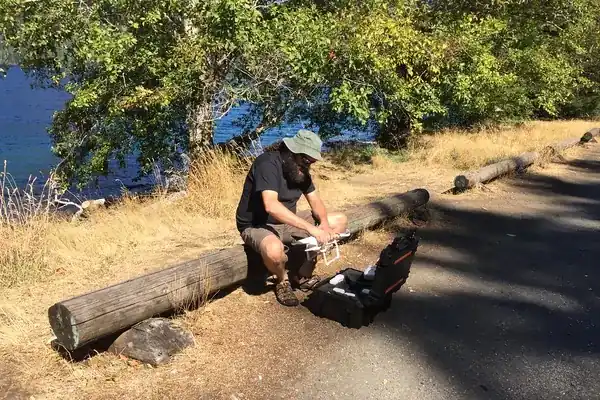 Pilot preparing a drone before take-off by a lake