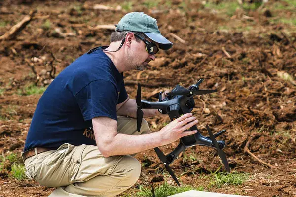 Officer preparing a drone during a pilot training session