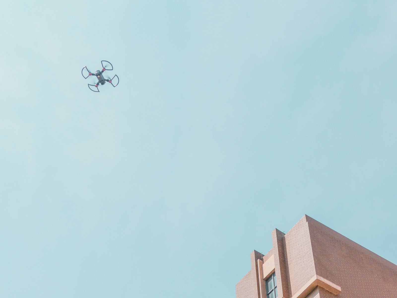 Drone flying close to a building facade for inspection