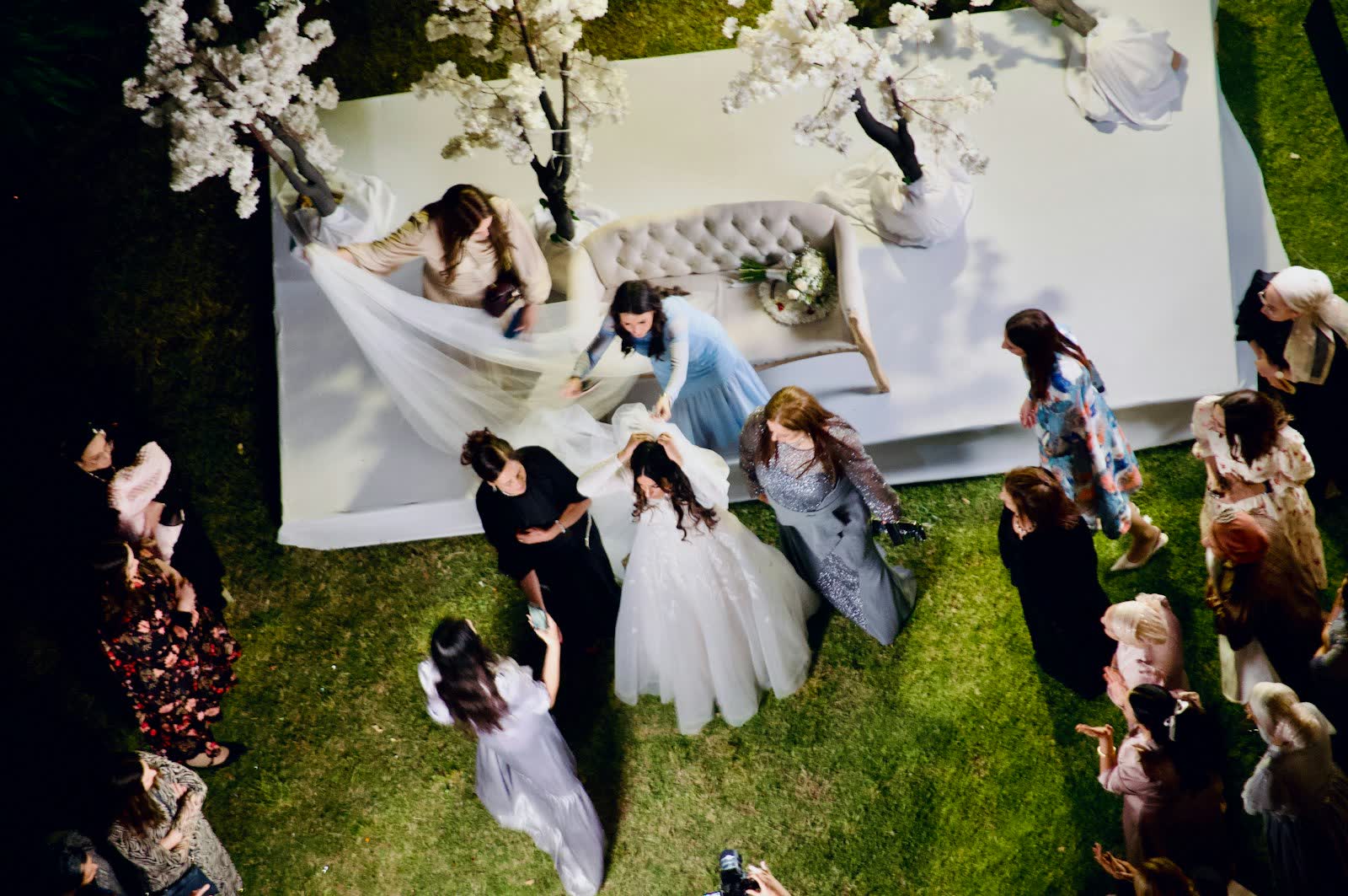 Bride and guests seen from above during an outdoor wedding ceremony