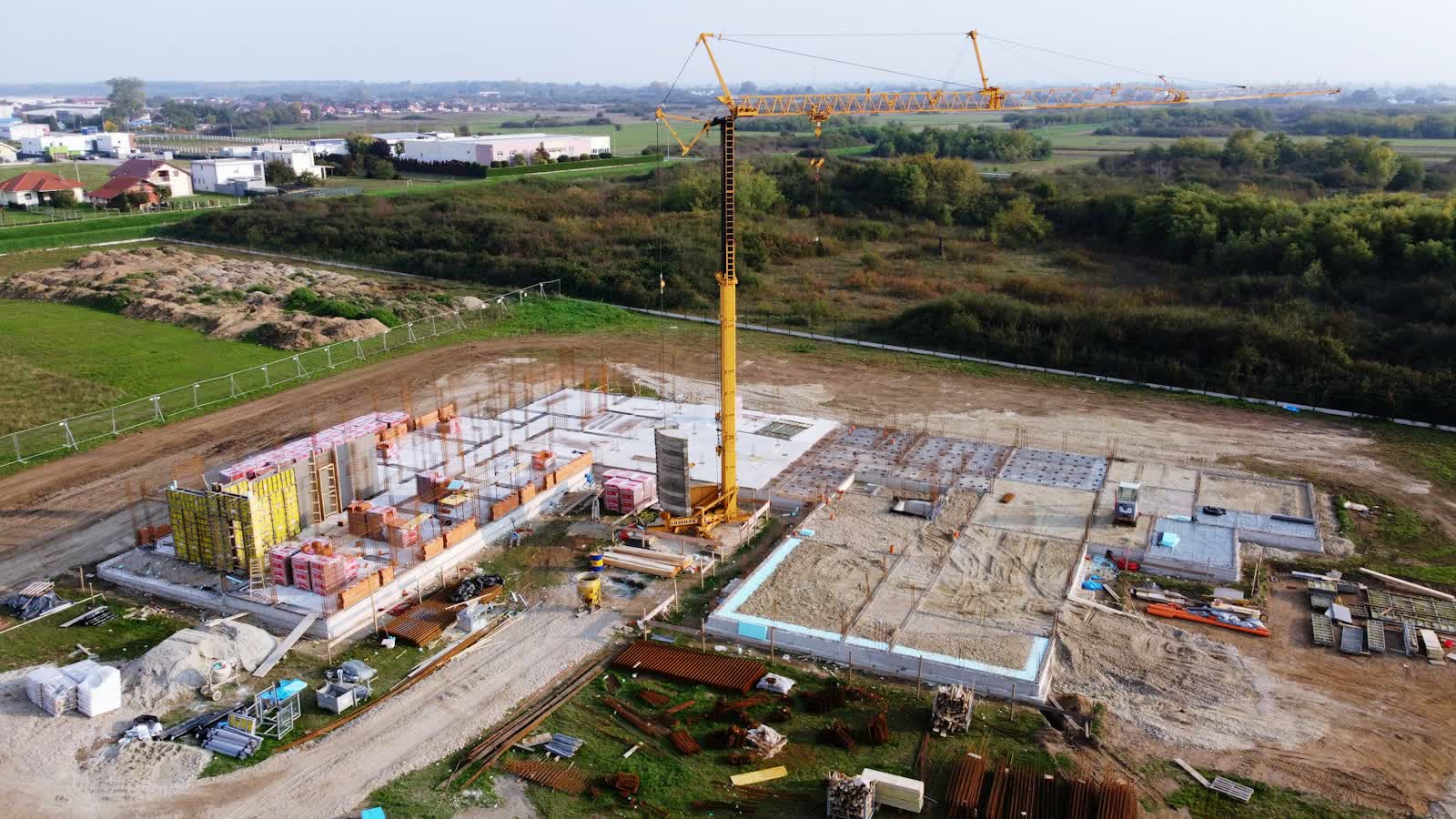 Aerial view of a construction site with a tower crane