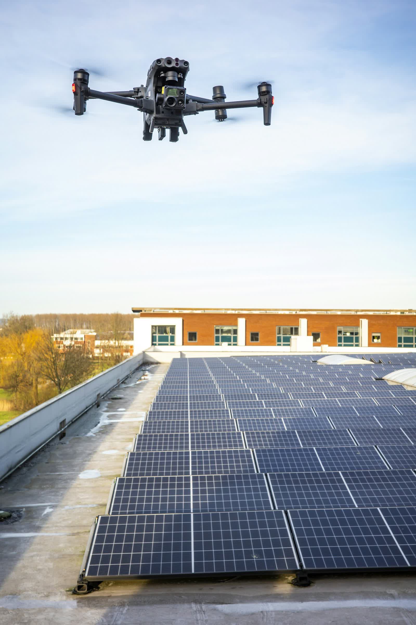Thermal-camera drone inspecting rooftop solar panels
