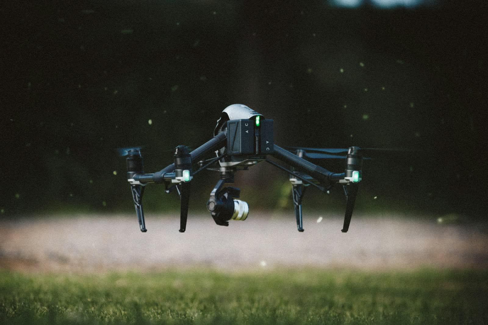 Cinema drone with stabilized camera gimbal flying at low altitude